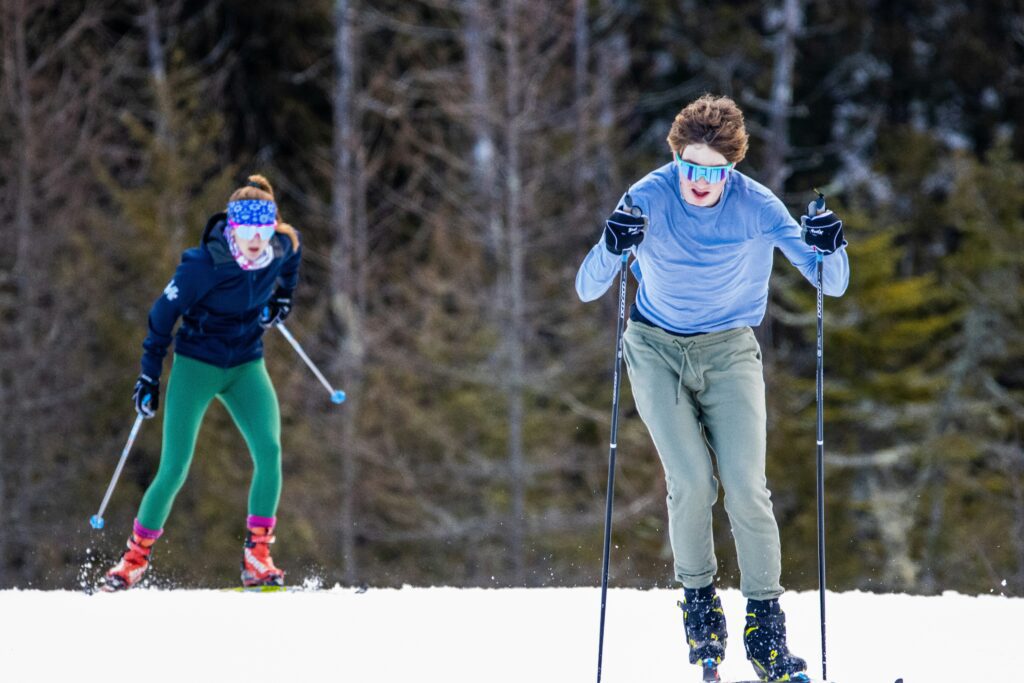 man and woman cross country skiing. Photo credit: Aaron Doucett