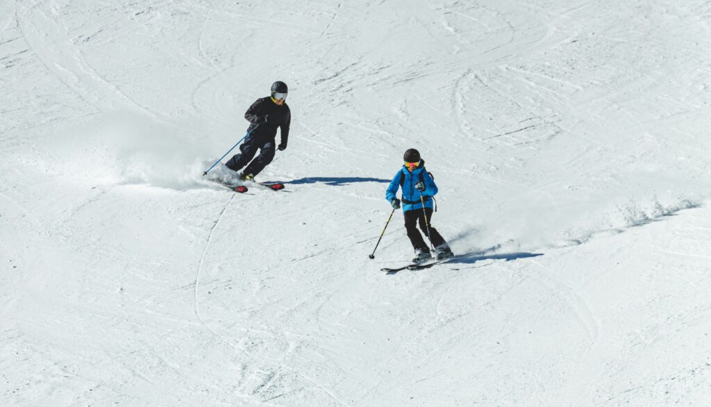 two skiiers on a mountain in vermont